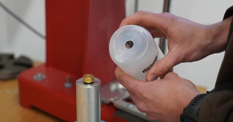 Punching the hole for the valve in the bottle body